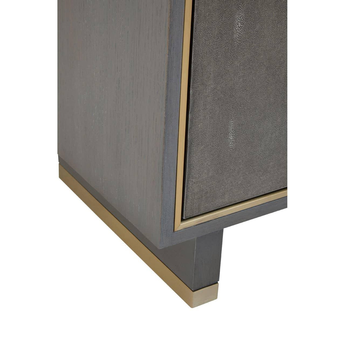 Close-up of wooden cabinet corner with gold trim and textured grey panel