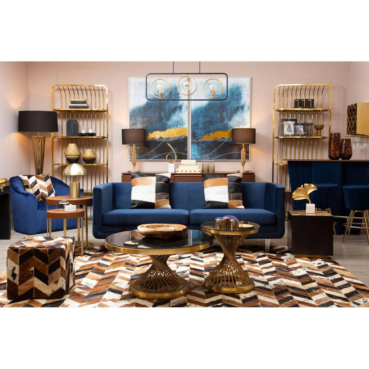 Blue velvet sofa set with gold frame coffee tables, accent chair and geometric rug in living room