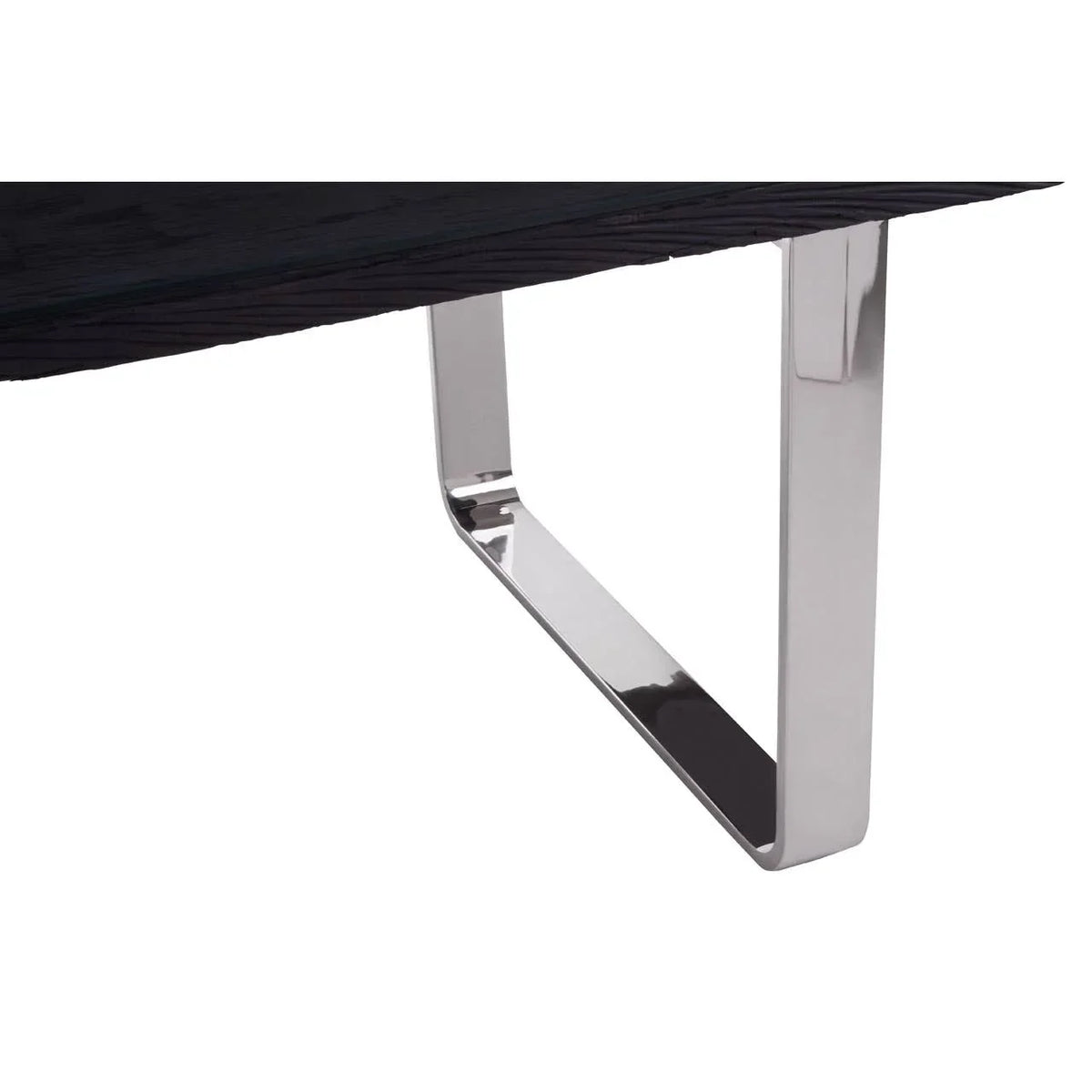 Closeup of dining table with black wood top and chrome metal leg