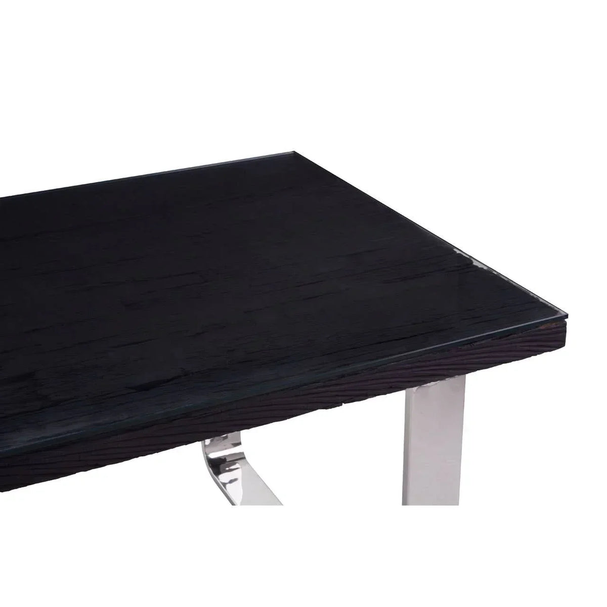 Black wood dining table corner with glass top and chrome metal leg