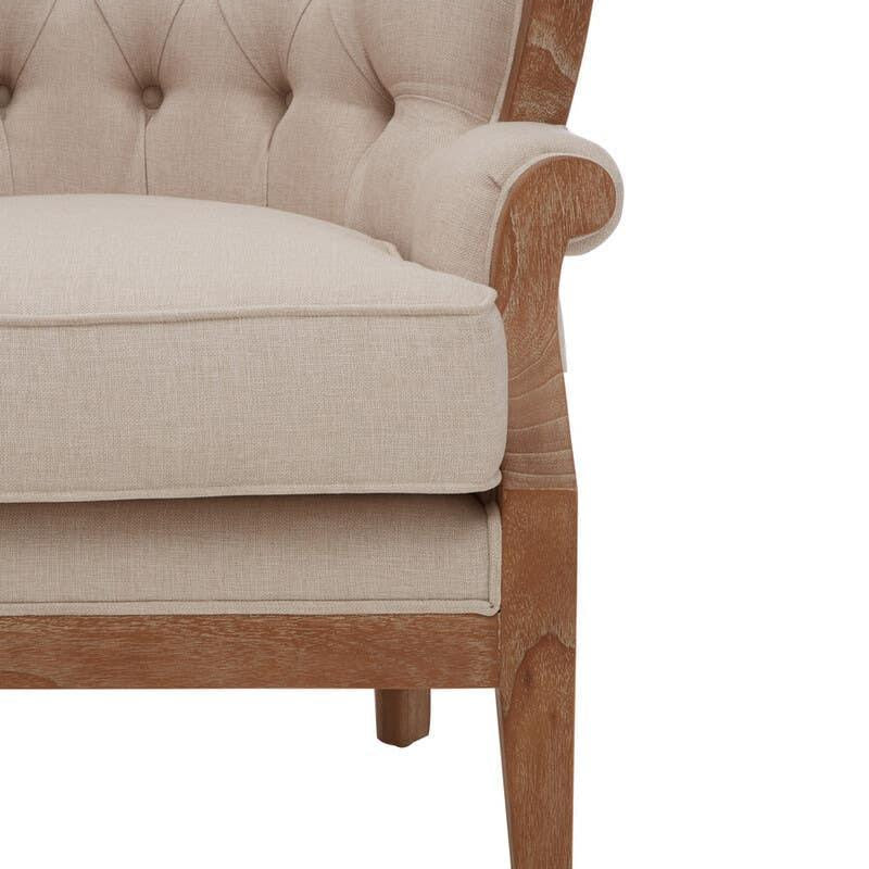 Beige upholstered armchair with button-tufted back and light wood frame, front side view