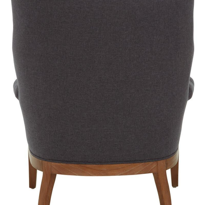 Back view of dark grey upholstered armchair with wooden legs