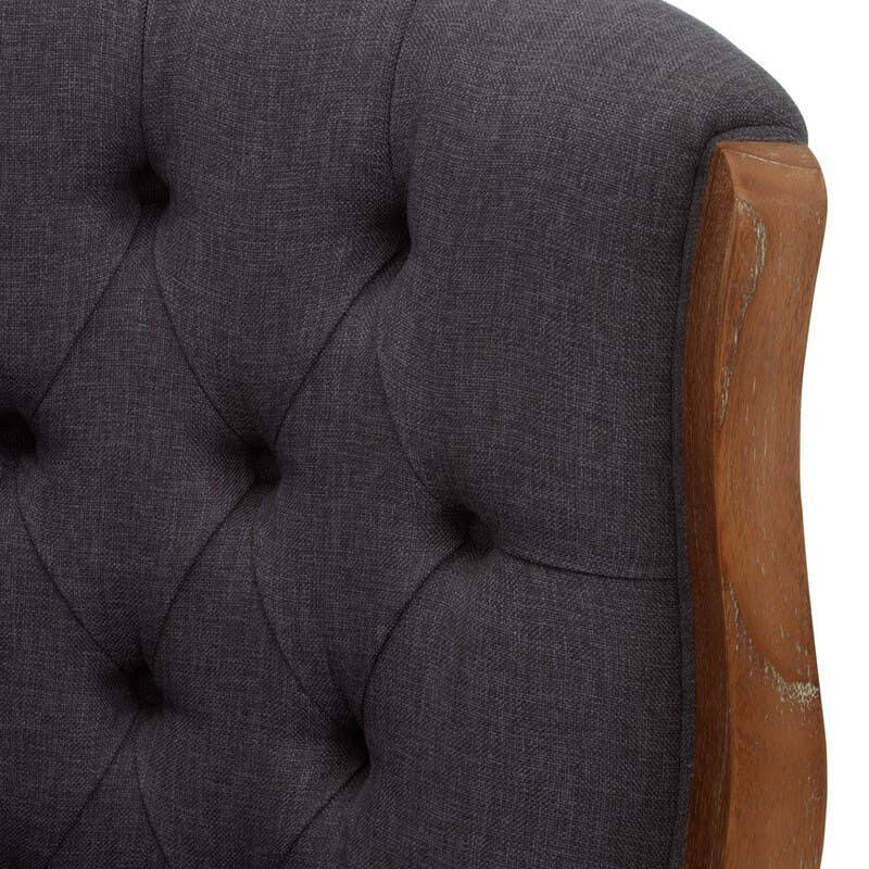 Tufted dark grey sofa back with wooden frame detail