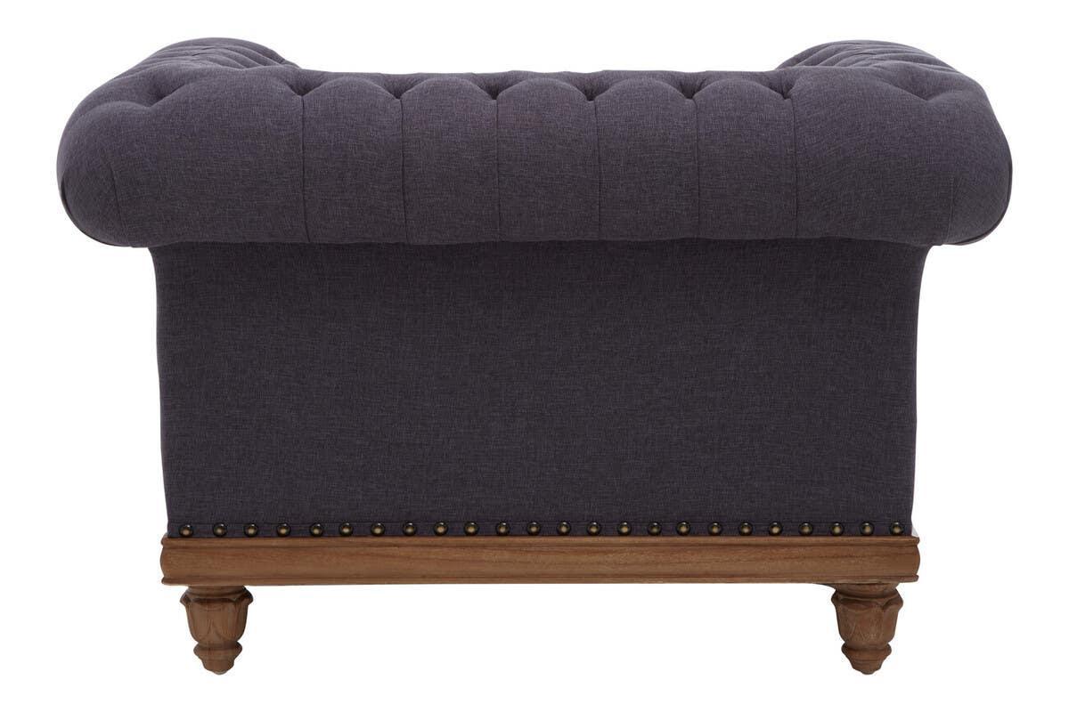 Back view of dark grey sofa with tufted upholstery and wooden legs