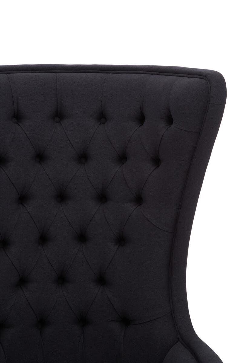 Close up of black tufted fabric armchair backrest with winged sides