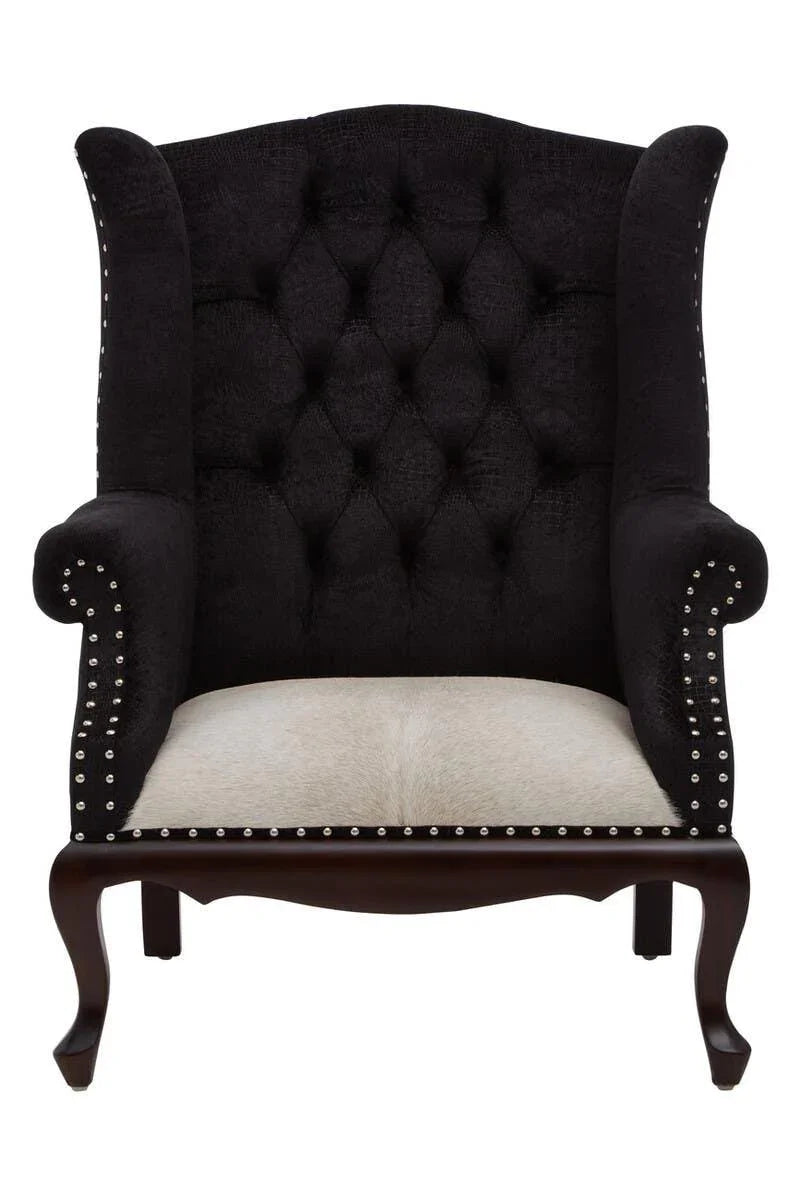 Button-tufted black wingback armchair with nailhead trim and light fabric seat