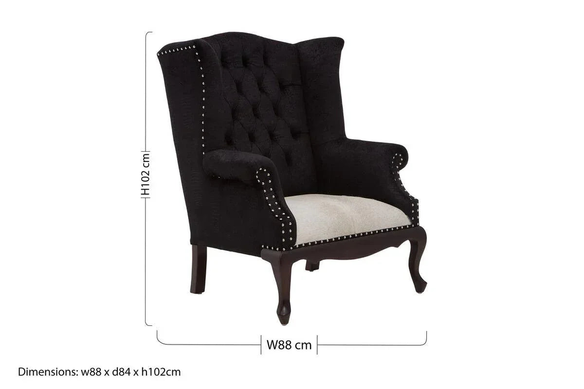 Black tufted wingback armchair with studded trim and cream seat, wood legs, dimensions shown