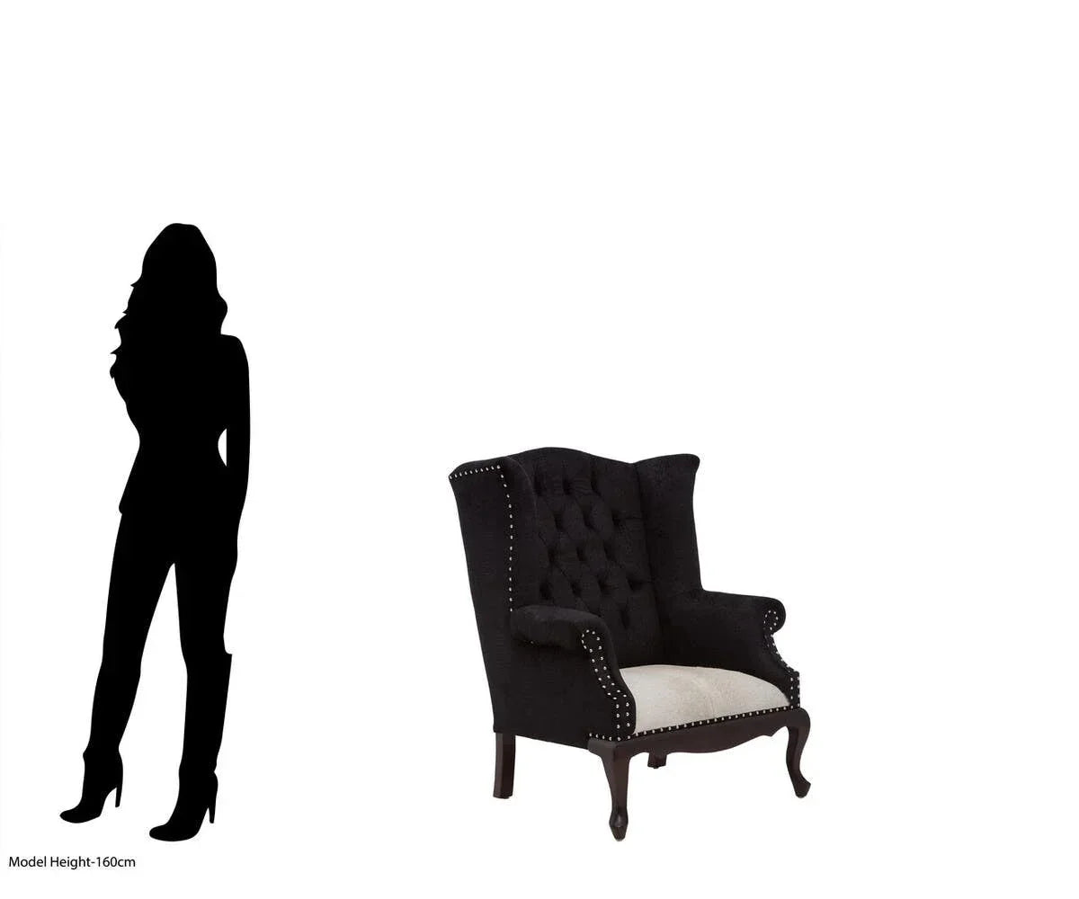 Black velvet wingback armchair with studded trim and cream seat, size comparison with person