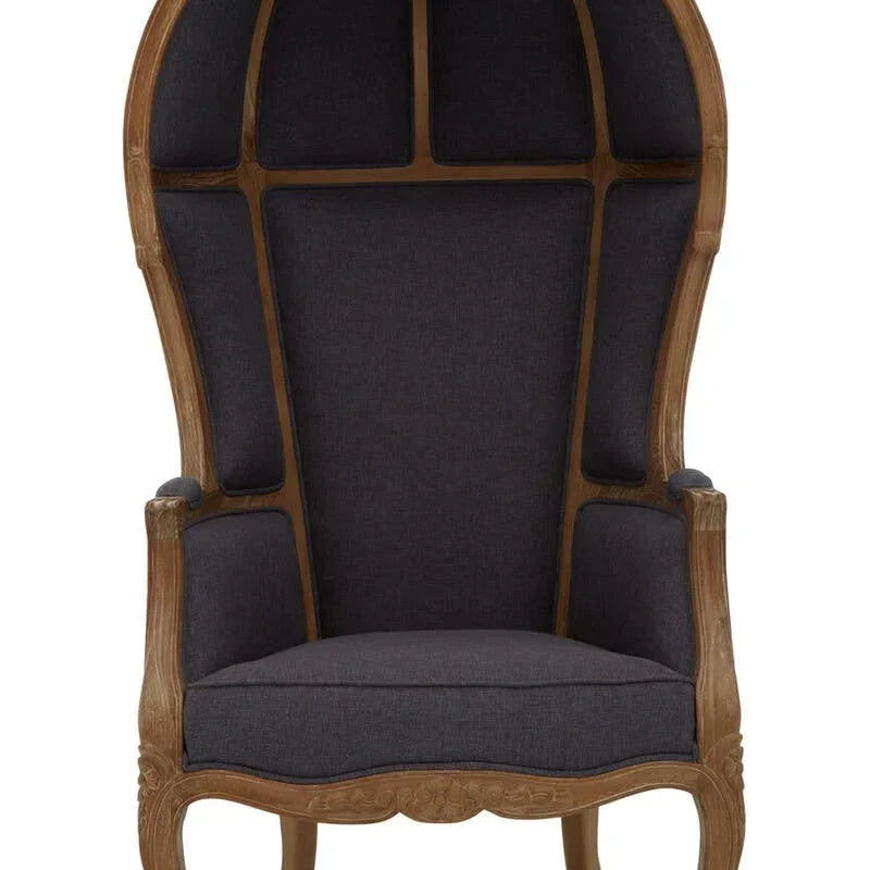 High back dome chair with dark upholstery and carved wooden frame, front view
