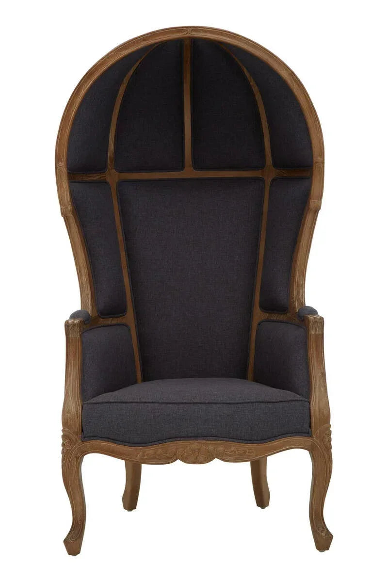 High back dome chair with dark upholstery and carved wooden frame, front view