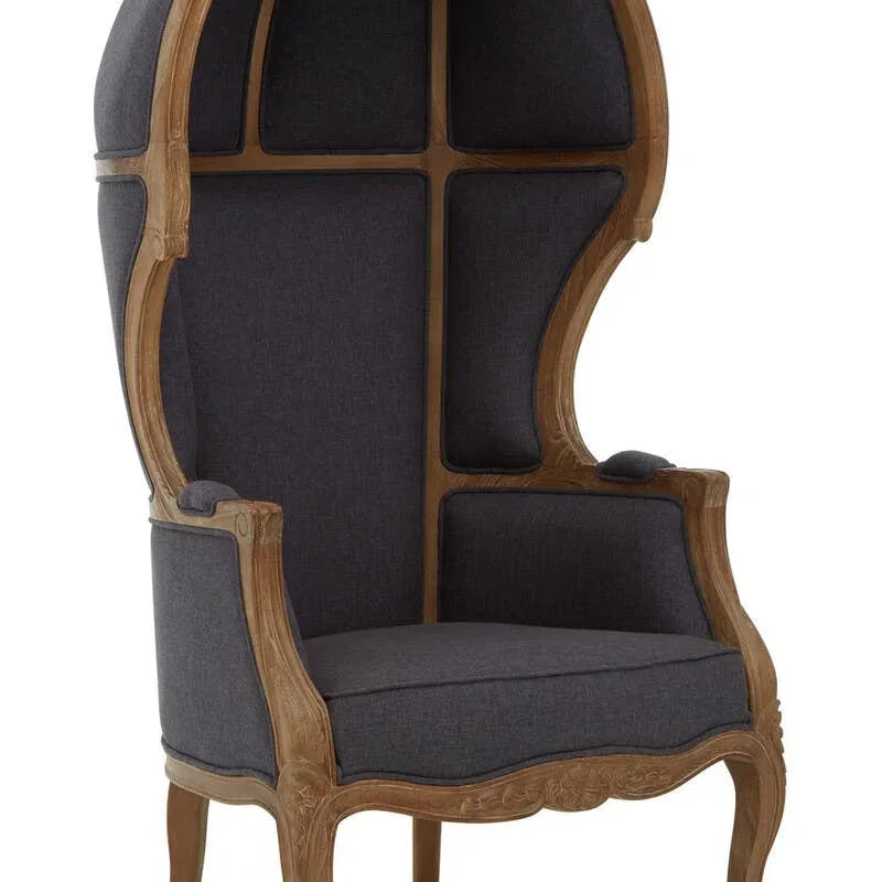 Dome canopy armchair with dark grey upholstery and carved wooden frame