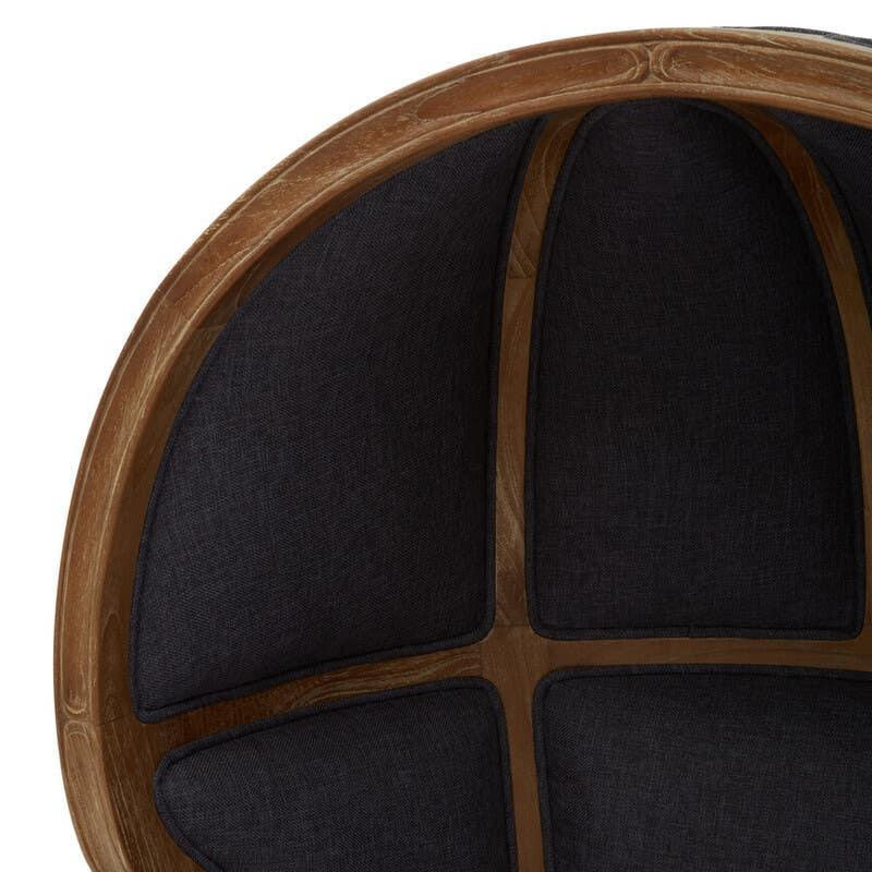 Curved wooden armchair with black upholstered panels on the backrest, close-up view