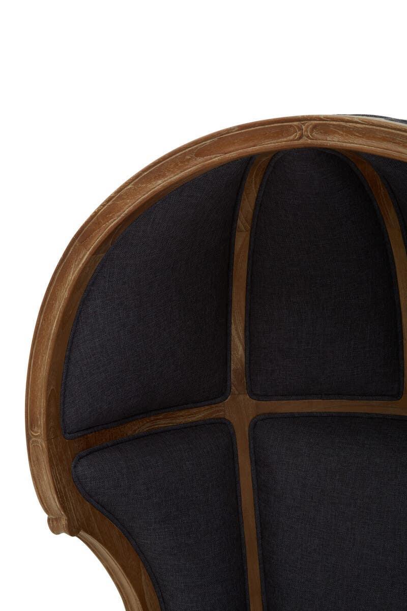 Curved wooden armchair with black upholstered panels on the backrest, close-up view