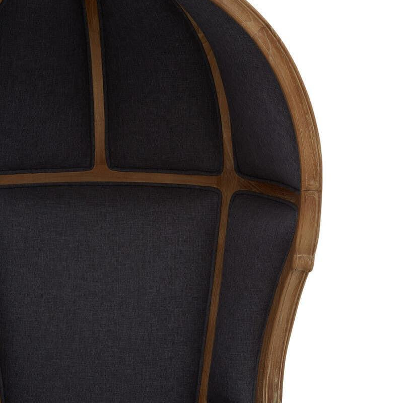 High back accent chair with dark upholstery and curved wood frame, partial front view