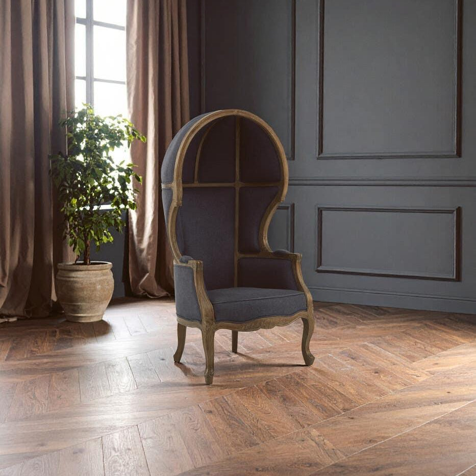 Dark grey upholstered dome canopy armchair with wooden frame in modern living room