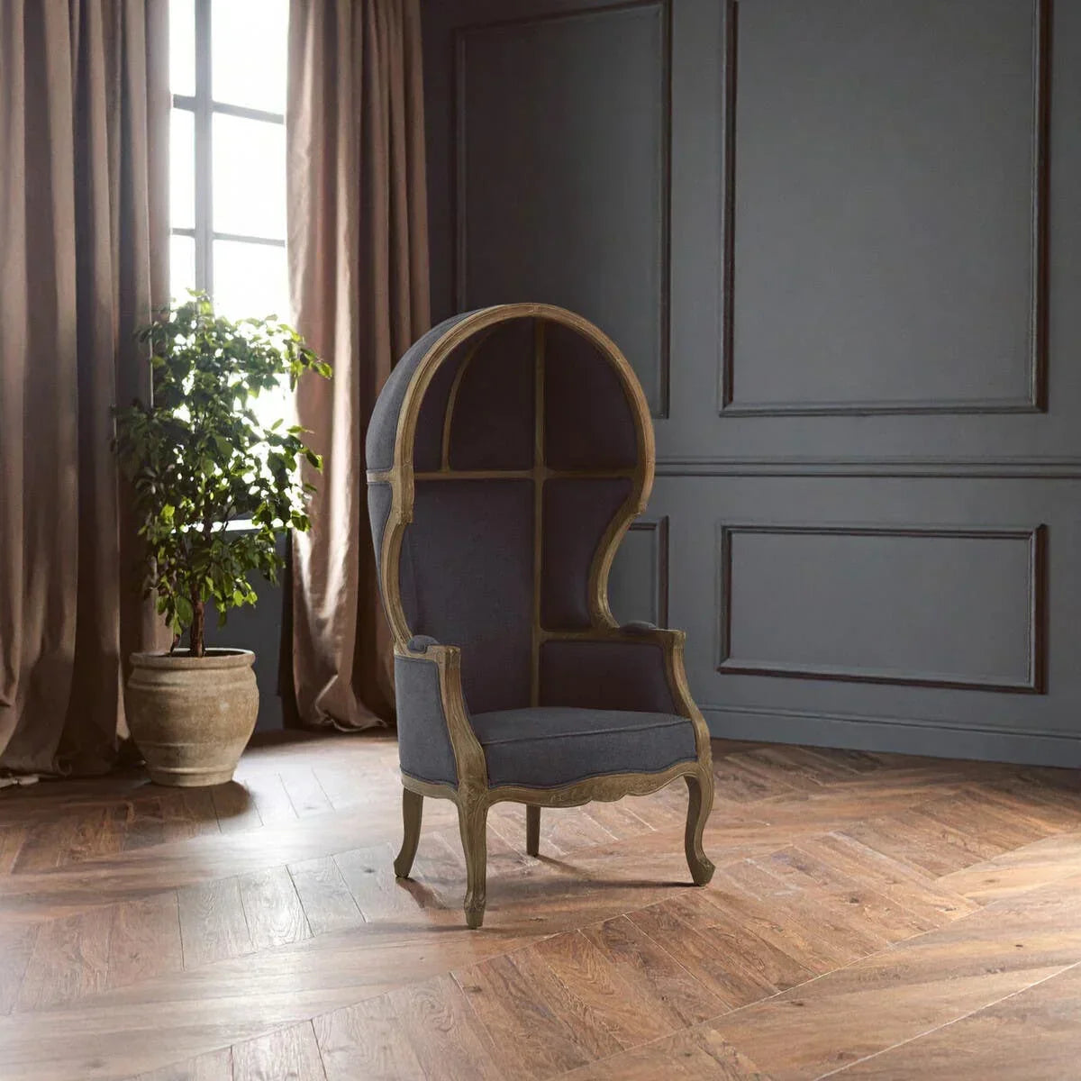 High back dome armchair with wood frame and dark upholstery in classic decorated room
