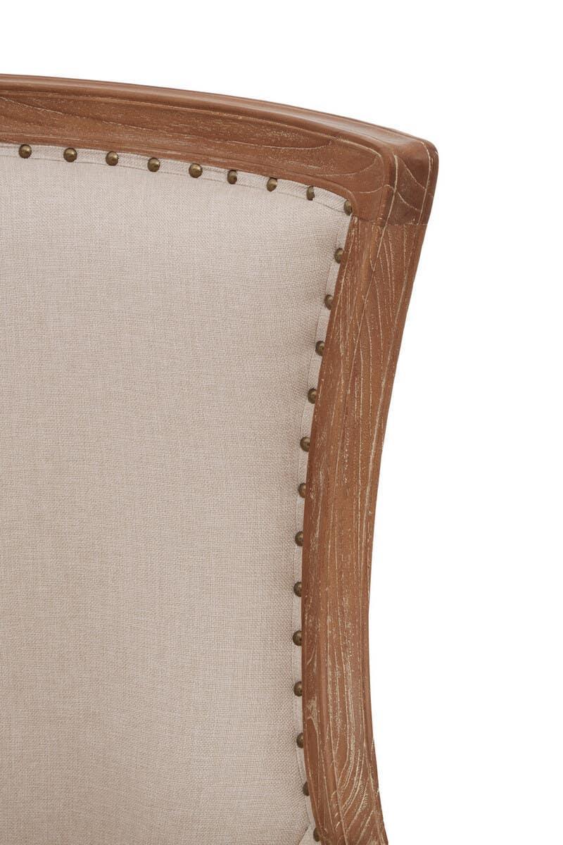 Beige upholstered chair back with wooden frame and decorative stud detail, close-up view