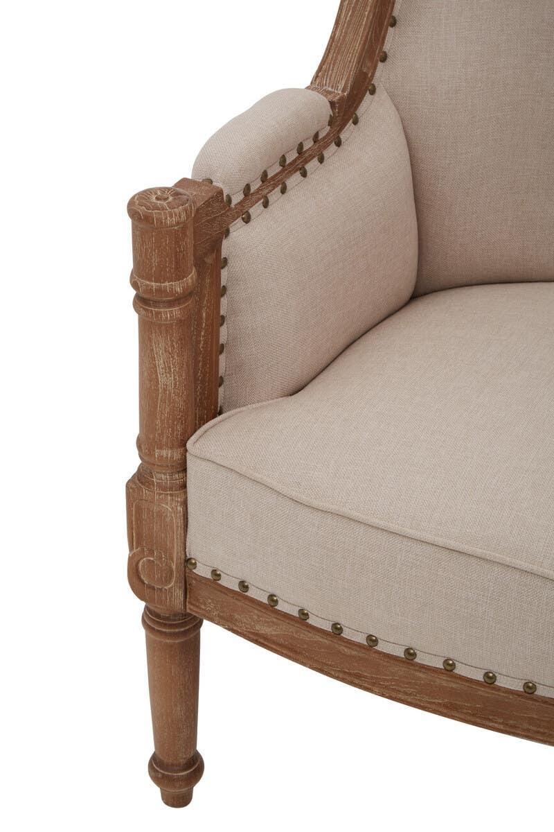 Wooden armchair corner with beige linen upholstery and decorative stud detail