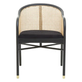 Black dining chair with cane backrest, rounded arms, cross base and gold foot accents
