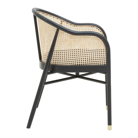 Rattan dining chair with black metal frame and cane backrest, angled rear view