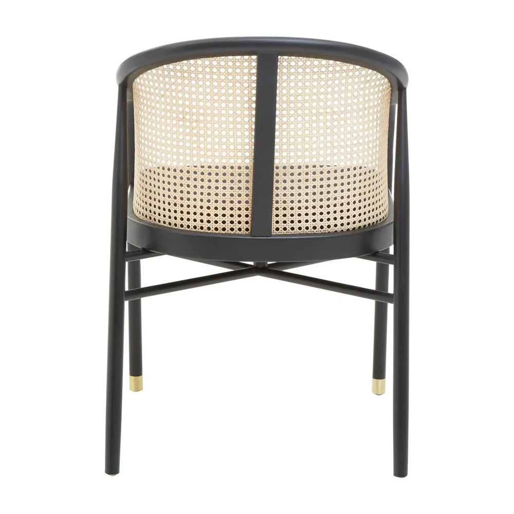 Black dining chair with cane rattan backrest and gold tipped legs, rear angle view