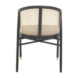 Black dining chair with cane rattan backrest and gold tipped legs, rear angle view