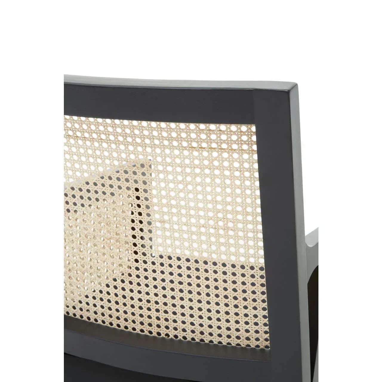 Close-up of dining chair with black wooden frame and woven cane backrest