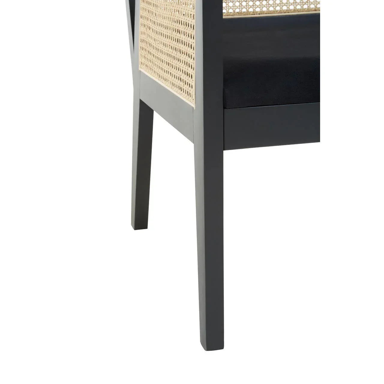 Close-up of black wooden dining chair leg with rattan panel and black seat cushion