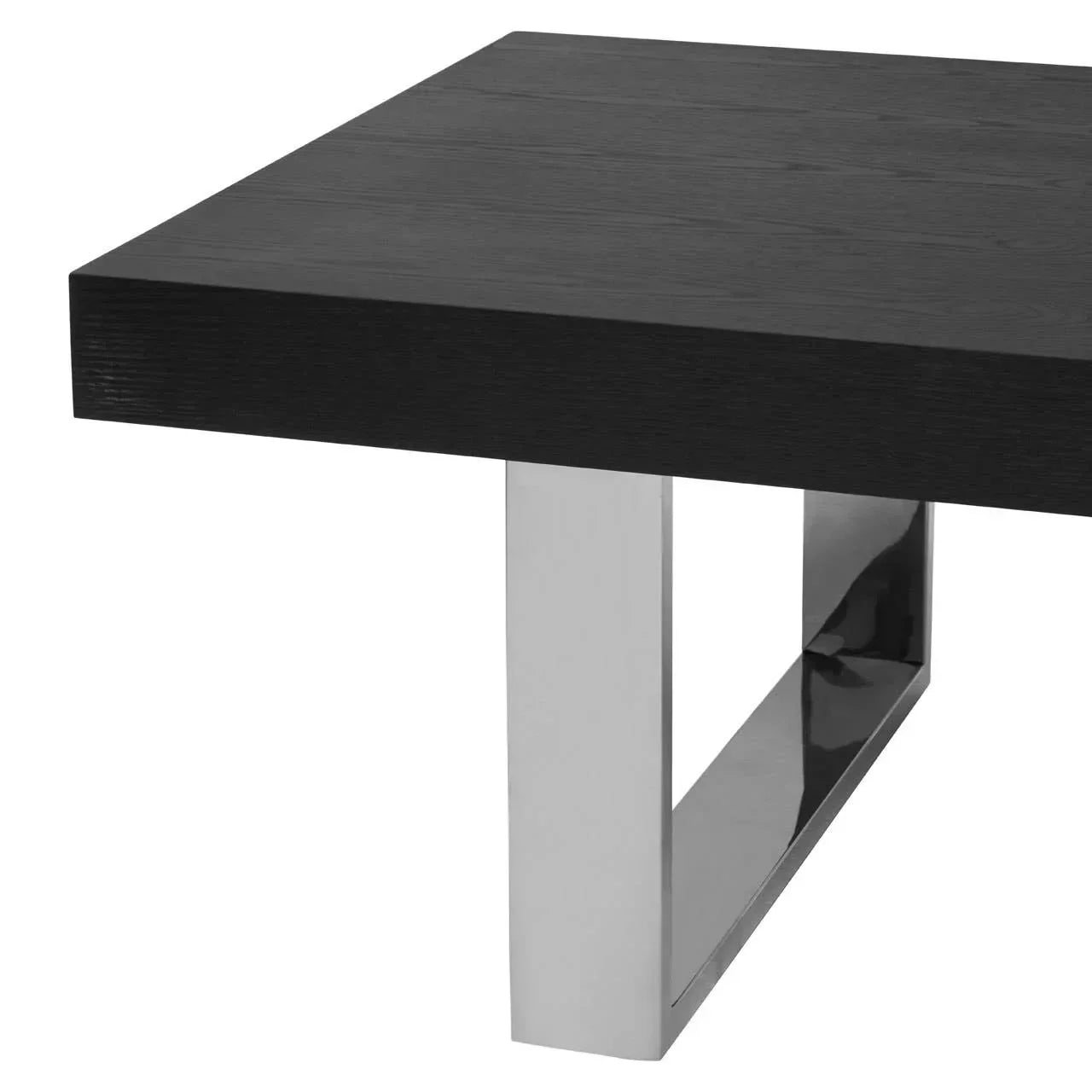 Black wood coffee table with chrome metal leg, close-up on modern corner detail