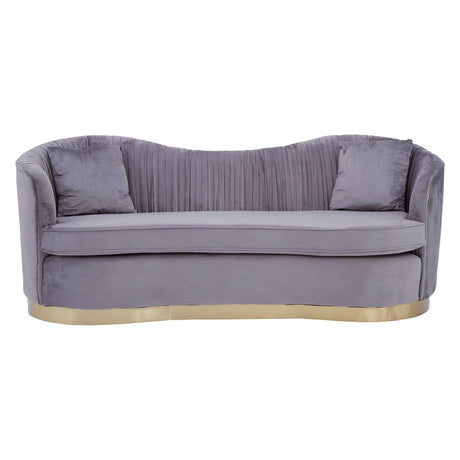 Three-seat sofa upholstered in pleated grey velvet with a curved backrest and two matching cushions. The base features a sleek gold trim, adding an elegant touch to the overall design