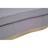 Pleated grey velvet upholstery of a three-seat sofa with a smooth, rounded edge and a light-colored base. The fabric appears soft and luxurious, showcasing subtle texture and depth