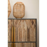 Textured wooden cabinet featuring a geometric pattern on the doors, with a sleek black frame and gold handles. A woven lantern sits on top, adding a natural element to the decor. The background is a neutral wall, enhancing the cabinet's warm tones
