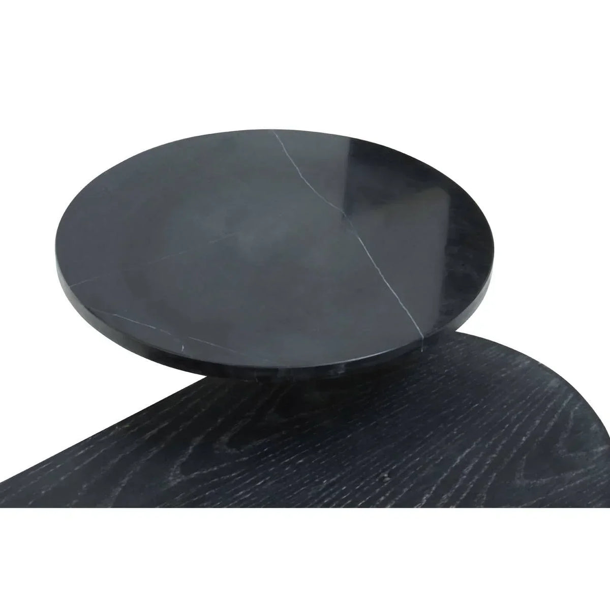 Round black marble coffee table top with subtle white veining and wood surface detail