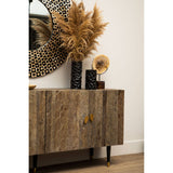 Tall cabinet made of recycled elm wood with a natural finish, featuring two doors and a sleek design. The cabinet is complemented by decorative items on top, including a large round mirror, a black vase with dried pampas grass, and a vintage-style speaker. The setting has a light-colored wall and wooden flooring, creating a warm and inviting atmosphere