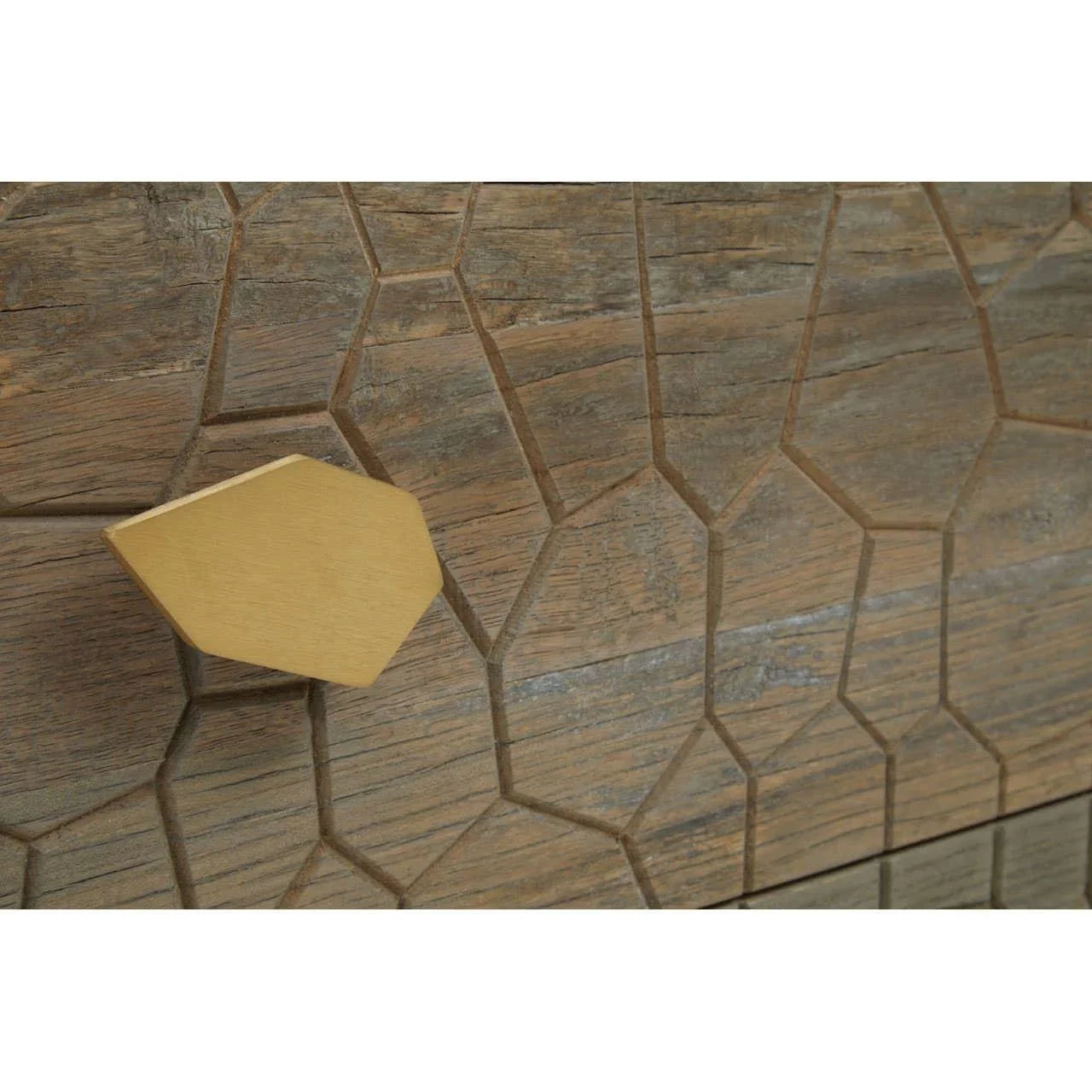 Geometric gold drawer handle on textured wood furniture with honeycomb pattern