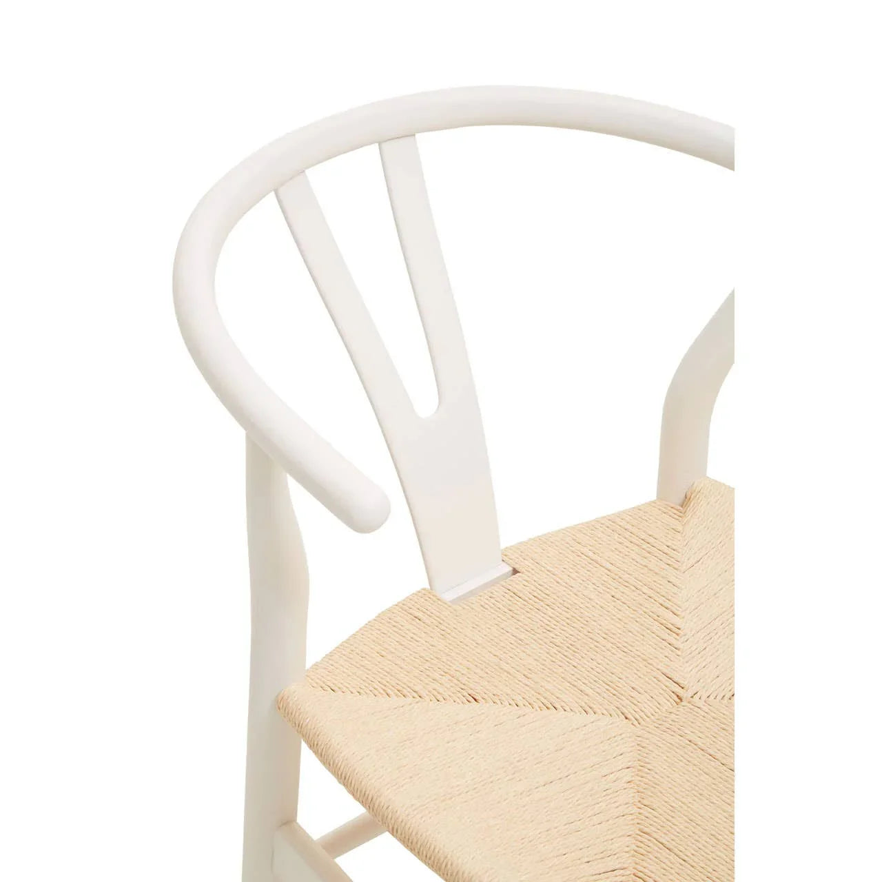 White dining chair with curved backrest and woven natural seat, angled side detail