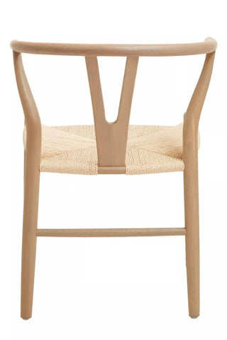 Natural wood dining chair with woven seat, shown from the back angle