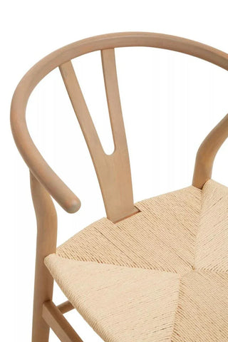 Curved wood dining chair with natural woven seat and light timber finish