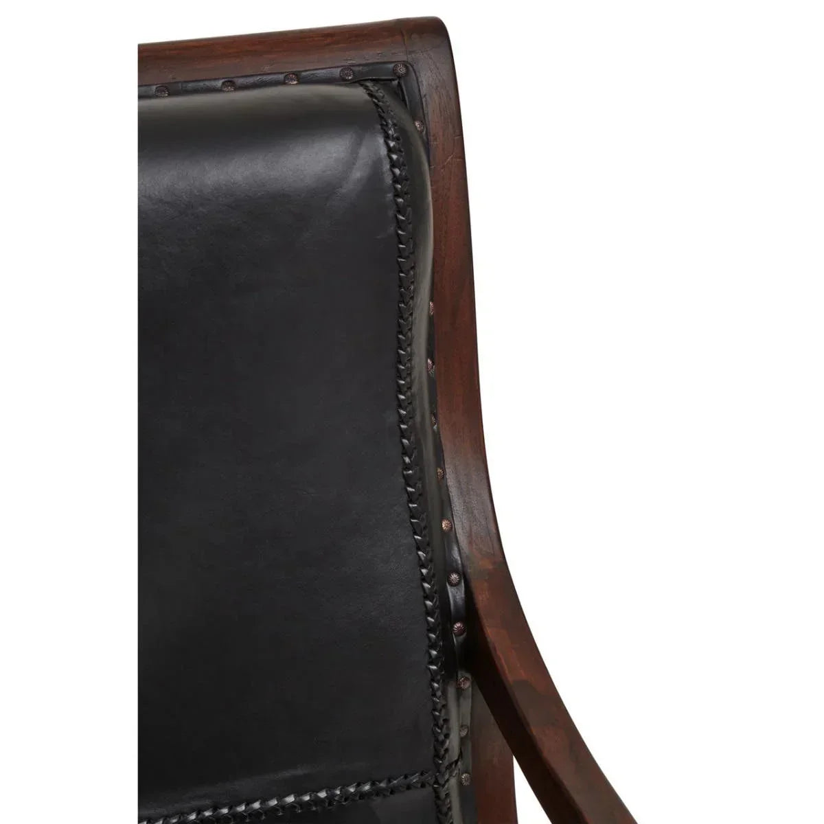 Close-up of black leather chair backrest with dark wood frame and stud detailing