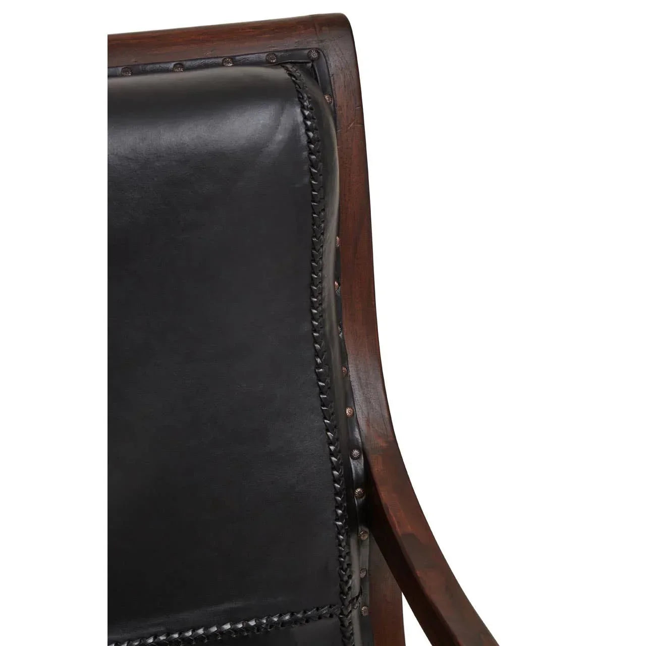 Close-up of wooden chair with black leather backrest and brass stud detailing