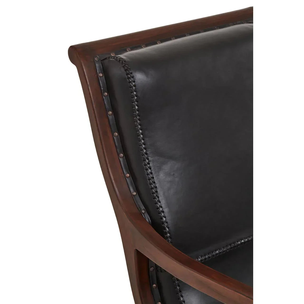 Closeup of black leather chair backrest with dark wood frame and stud detailing