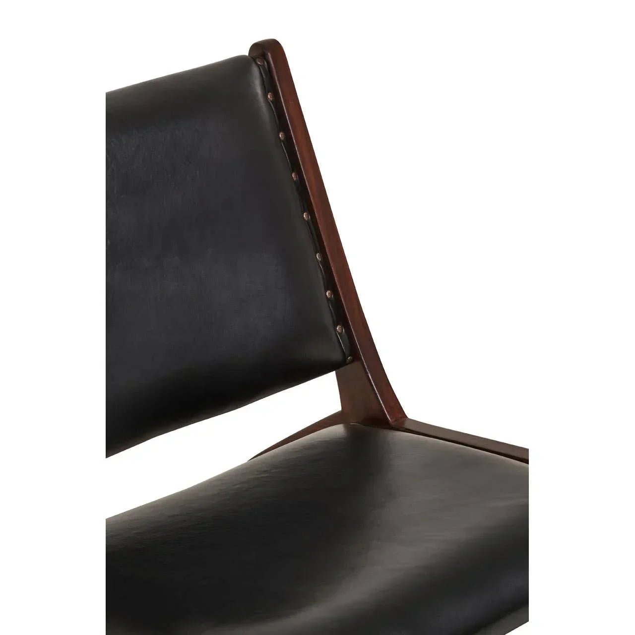 Closeup of black leather dining chair with dark wood frame and visible stud detailing