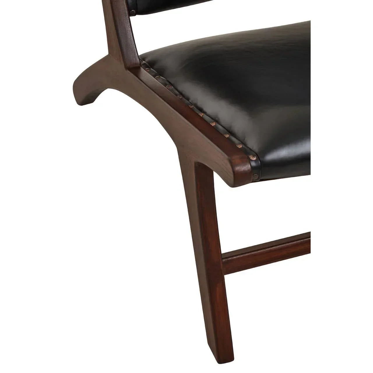 Closeup of dark wood chair leg and black leather seat with stud detail