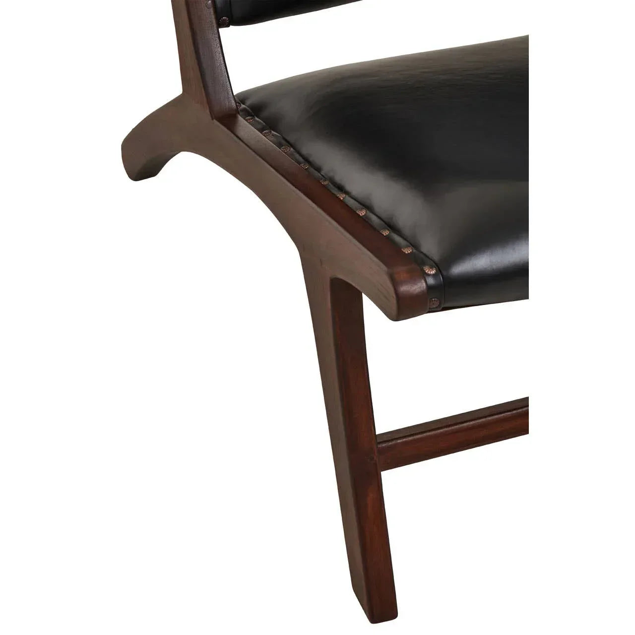 Dark wood dining chair leg with black leather upholstered seat close-up