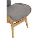 Dark grey velvet chair featuring a winged back design, with a smooth, plush seat cushion and elegantly curved edges.
