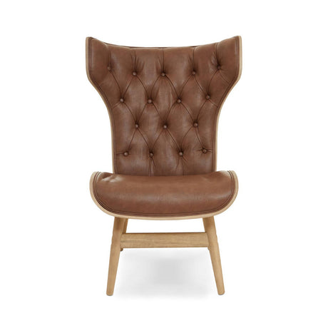 Brown leather effect chair featuring a winged back design with tufted detailing. The chair has a smooth, rounded seat and is supported by light-colored wooden legs.