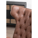 Brown leather effect chair featuring a winged back design with tufted detailing and button accents.