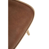 Brown leather effect chair featuring a winged back design, showcasing a smooth, textured surface and light wooden legs.