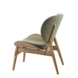 Green velvet chair featuring a rounded backrest and a sleek seat, supported by a light grey elm wood frame with angled legs.