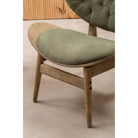 Green velvet chair featuring a plush, rounded seat and backrest, complemented by a light grey elm wood frame.